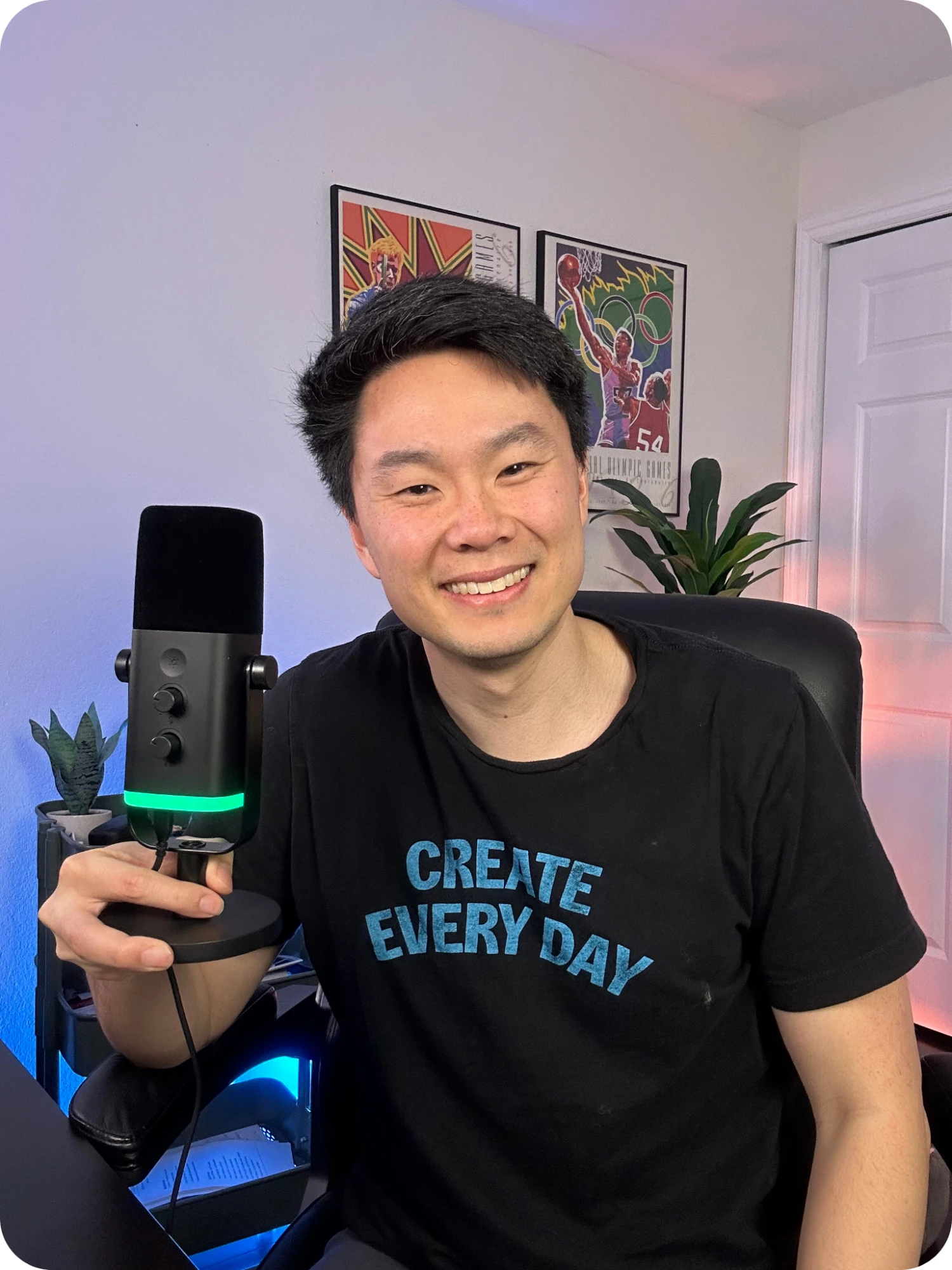 Preston Chin holding a microphone